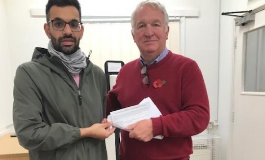 Suliman Rafiq presents the Bennetts End Road road safety petition to Sir Mike Penning MP