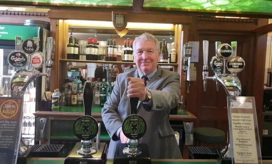 Sir Mike Penning pulls a pint of Mad Squirrel in the Strangers Bar in Parliament.