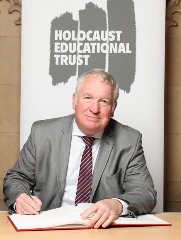 Sir Mike Penning MP signs Holocaust Educational Trust Book of Commitment.
